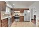 Modern kitchen with stainless steel appliances and wood cabinets at 16193 E Dickenson Pl, Aurora, CO 80013