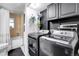 Functional laundry room with modern appliances, a convenient utility sink, and ample storage at 16193 E Dickenson Pl, Aurora, CO 80013