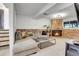 Cozy living room with exposed brick fireplace, comfortable seating, and soft lighting at 16193 E Dickenson Pl, Aurora, CO 80013