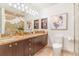 Elegant bathroom featuring granite countertops, dark wood cabinetry, and a glass-enclosed shower at 1201 N Williams St # 3B, Denver, CO 80218