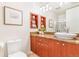 Stylish bathroom featuring custom vanity with granite countertop and decorative storage shelves at 1201 N Williams St # 3B, Denver, CO 80218