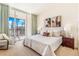 Bright bedroom with king bed, neutral decor, art and patio access at 1201 N Williams St # 3B, Denver, CO 80218