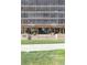 The building entrance features steps and symmetrical landscaping against a wall of glass-fronted balconies at 1201 N Williams St # 3B, Denver, CO 80218