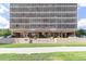 Apartment building exterior with manicured lawn, planters, and covered entryway at 1201 N Williams St # 3B, Denver, CO 80218