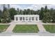 A park pavilion with white columns is framed by green lawns and mature trees under a cloudy sky at 1201 N Williams St # 3B, Denver, CO 80218