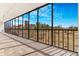 Large patio with tiled flooring and black metal railings overlooking green space and city buildings at 1201 N Williams St # 3B, Denver, CO 80218