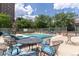 Community swimming pool surrounded by tables and chairs, offering a relaxing outdoor space at 1201 N Williams St # 3B, Denver, CO 80218