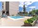 Community swimming pool surrounded by lounge chairs and lush greenery on a sunny day at 1201 N Williams St # 3B, Denver, CO 80218