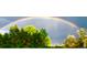 Stunning shot of a rainbow arching over the trees in the serene backyard at 1037 Wagonwheel Gap Rd, Boulder, CO 80302