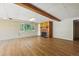 Large basement area with wood-look flooring, brick walls, wood beam and fireplace at 1037 Wagonwheel Gap Rd, Boulder, CO 80302