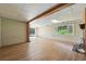 Large basement area with wood-look flooring, brick walls, wood beam and fireplace at 1037 Wagonwheel Gap Rd, Boulder, CO 80302