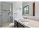 Bathroom featuring glass enclosed shower, tile counter and floors, and decorative mirror at 1037 Wagonwheel Gap Rd, Boulder, CO 80302