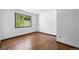 Minimalist bedroom with hardwood floors and a scenic view of nature through the window at 1037 Wagonwheel Gap Rd, Boulder, CO 80302