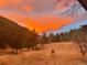 Golden sunset colors the sky, creating a beautiful view from the property at 1037 Wagonwheel Gap Rd, Boulder, CO 80302