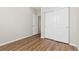 Clean, minimalist bedroom with wood floors, features a closet with sliding doors and an entrance to another room at 27639 E 7Th Ln, Aurora, CO 80018