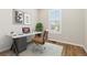 Stylish home office setup with a modern desk, comfortable chair, laptop, and natural light from the window at 27639 E 7Th Ln, Aurora, CO 80018