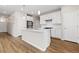 Stylish kitchen with white cabinets, stainless steel appliances, and hardwood floors at 27639 E 7Th Ln, Aurora, CO 80018