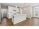 Bright, modern kitchen features white cabinets, stainless steel appliances, and an island at 27639 E 7Th Ln, Aurora, CO 80018