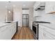Beautiful kitchen with white cabinets, stainless steel appliances, and hardwood floors at 27639 E 7Th Ln, Aurora, CO 80018