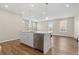 Modern kitchen island with stainless steel appliances and views to the living space at 27639 E 7Th Ln, Aurora, CO 80018