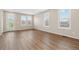 Bright living room with hardwood floors, large windows with shutters, and neutral walls at 27639 E 7Th Ln, Aurora, CO 80018