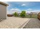 Paver patio with gravel border and wooden fence overlooking green space at 27639 E 7Th Ln, Aurora, CO 80018