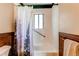 Classic bathroom with neutral tile and fixtures, including a shower-tub and safety bar at 1275 Niagara St, Denver, CO 80220