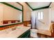 Clean and well-maintained bathroom with a combination shower and tub and a vanity at 1275 Niagara St, Denver, CO 80220