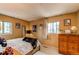 Bedroom with multiple windows, decorative artwork, and cozy furnishings at 1275 Niagara St, Denver, CO 80220