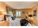 Comfortable bedroom featuring a plush bed, stylish decor, and ample natural light from the window at 1275 Niagara St, Denver, CO 80220
