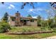 Charming single-story home with a stone chimney and well-maintained front yard at 1275 Niagara St, Denver, CO 80220