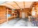 Attached garage with unfinished ceiling, wood framing, built-in shelves, and concrete floor at 1275 Niagara St, Denver, CO 80220