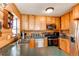 Cozy kitchen with wood cabinetry, countertops, and stainless steel appliances at 1275 Niagara St, Denver, CO 80220
