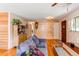 Open-concept living room with a wooden accent wall and hardwood flooring at 1275 Niagara St, Denver, CO 80220