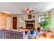 Cozy living room featuring a decorative fireplace, ceiling fan, and hardwood floors at 1275 Niagara St, Denver, CO 80220