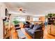 Bright living space with hardwood floors, a fireplace, and an adjoining dining area at 1275 Niagara St, Denver, CO 80220