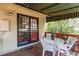 Cozy covered patio featuring outdoor seating, wood decking, and a retractable awning at 1275 Niagara St, Denver, CO 80220