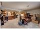 Basement features carpet, wood paneled walls, a minibar, and a seating area at 4231 S Fairplay Cir # A, Aurora, CO 80014