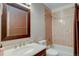 Bathroom with neutral tiling, framed mirror, and combination shower and tub at 4231 S Fairplay Cir # A, Aurora, CO 80014