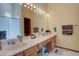 Bathroom featuring a long vanity with a sink and a lighted mirror at 4231 S Fairplay Cir # A, Aurora, CO 80014