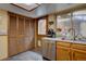Kitchen view with stainless steel dishwasher, double sink, and access door at 4231 S Fairplay Cir # A, Aurora, CO 80014