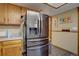 Kitchen featuring stainless steel refrigerator and wood cabinets at 4231 S Fairplay Cir # A, Aurora, CO 80014