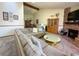 Spacious living room with a brick fireplace, plush seating, and lots of natural light at 4231 S Fairplay Cir # A, Aurora, CO 80014
