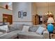 Living room showcasing a high ceiling, sky light, stylish couch, and adjacent dining area with chandelier at 4231 S Fairplay Cir # A, Aurora, CO 80014