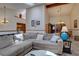 Cozy living area with vaulted ceiling, chandelier, comfortable couch, skylight, and view into dining area at 4231 S Fairplay Cir # A, Aurora, CO 80014