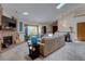 Bright living room featuring a fireplace, sky light, comfortable couch, and an adjacent dining area at 4231 S Fairplay Cir # A, Aurora, CO 80014