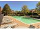 Community pool surrounded by lounge chairs and lush landscaping at 4231 S Fairplay Cir # A, Aurora, CO 80014