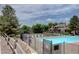 Community pool with sun loungers and ample seating surrounded by well-maintained landscaping at 4231 S Fairplay Cir # A, Aurora, CO 80014