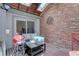 Relaxing sunroom with brick wall, skylights, and sliding glass door for indoor/outdoor living at 4231 S Fairplay Cir # A, Aurora, CO 80014