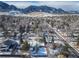 Aerial view of a snow-covered neighborhood with mountain views in the background at 1120 Hartford Dr, Boulder, CO 80305